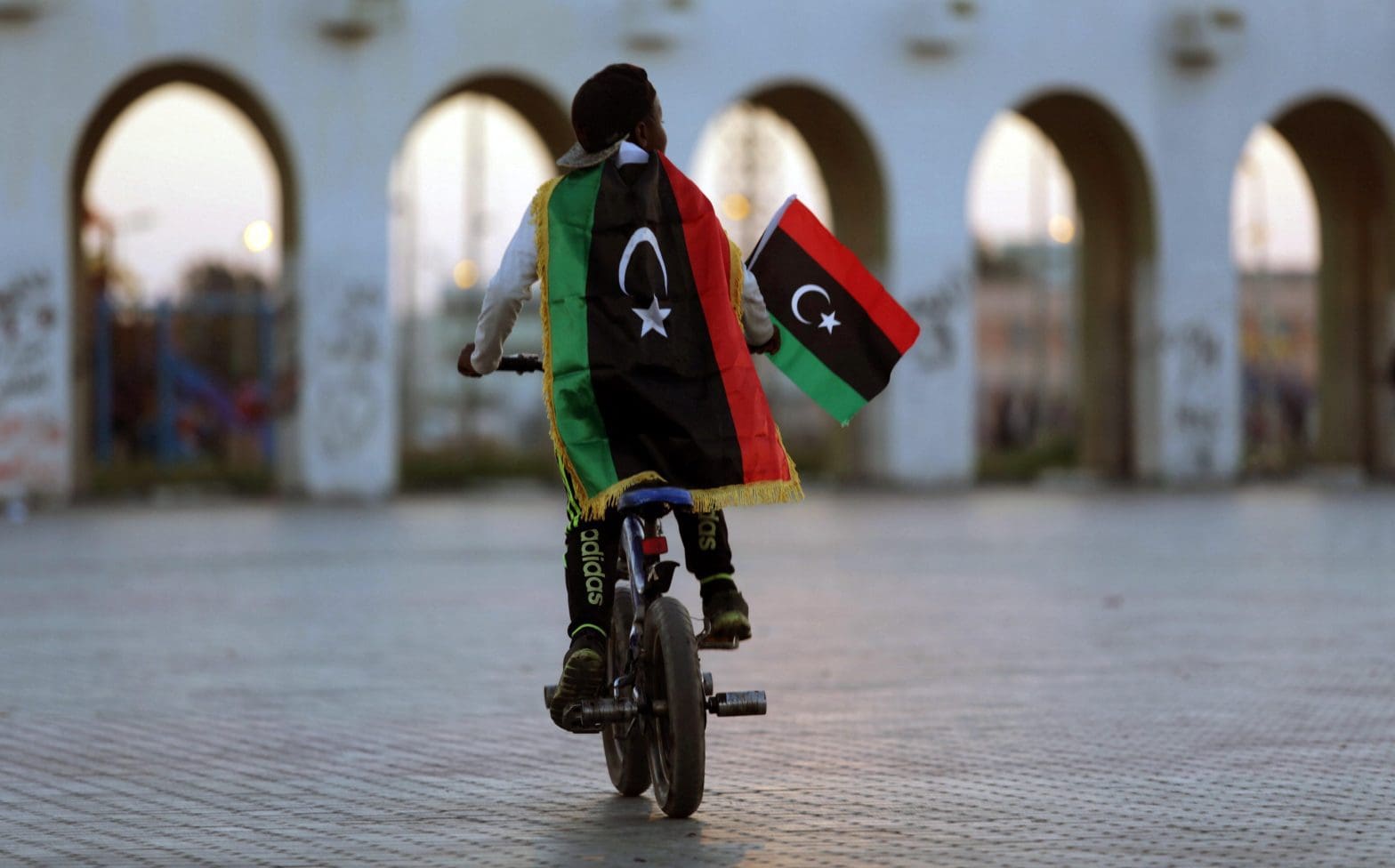 A boy wearing a Libyan flag takes part in a celebration marking the sixth anniversary of the Libyan revolution, in Benghazi, Libya February 17, 2017. REUTERS/Esam Omran Al-Fetori TPX IMAGES OF THE DAY - RTSZ7CB