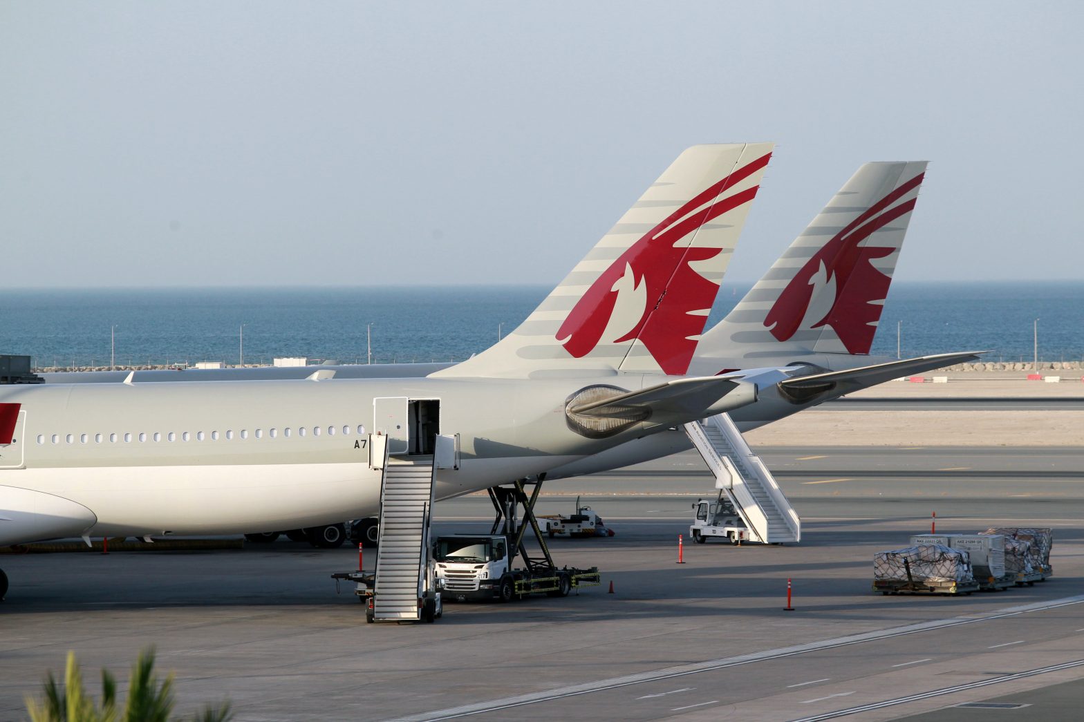 Qatar Airways aircrafts are seen at Hamad International Airport in Doha, Qatar June 12, 2017. REUTERS/Naseem Zeitoon - RTS16R4Z