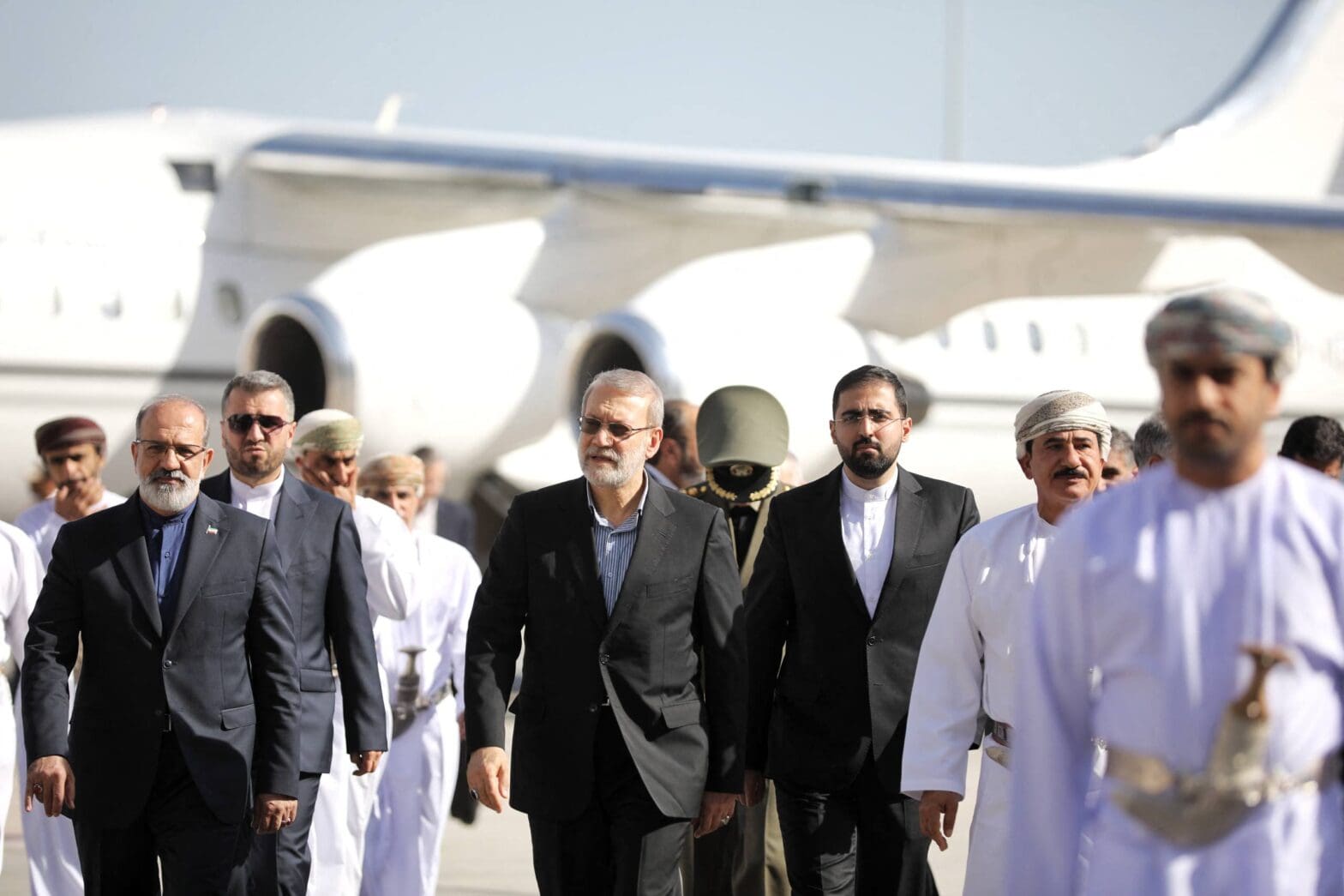 This photo released by Iran's Supreme National Security Council office shows Secretary of the Supreme National Security Council Ali Larijani (C) arriving in Muscat, Oman on February 10, 2026. (AFP)
